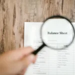 Balance Sheet with Magnifying Glass
