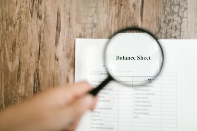Balance Sheet with Magnifying Glass